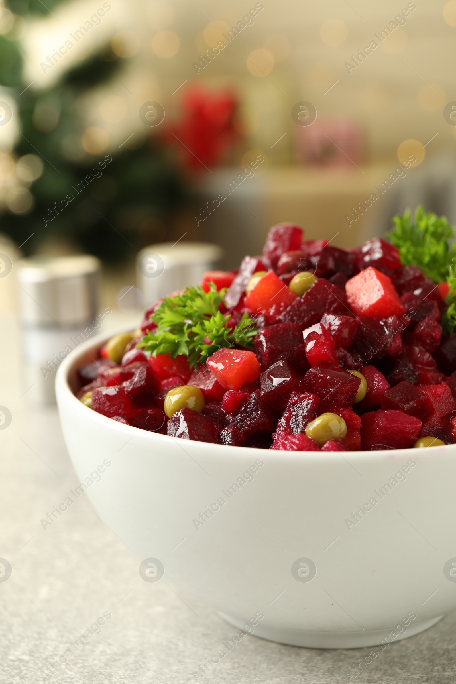 Photo of Traditional Russian salad vinaigrette on light table, closeup