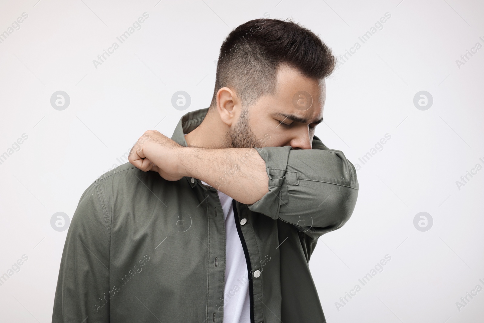 Photo of Sick man coughing on white background. Cold symptoms