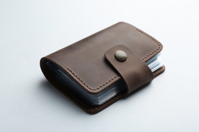 Photo of Stylish leather card holder on light grey background