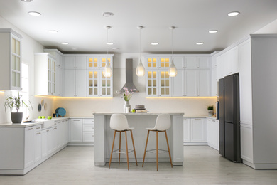 Photo of Modern kitchen interior with stylish white furniture