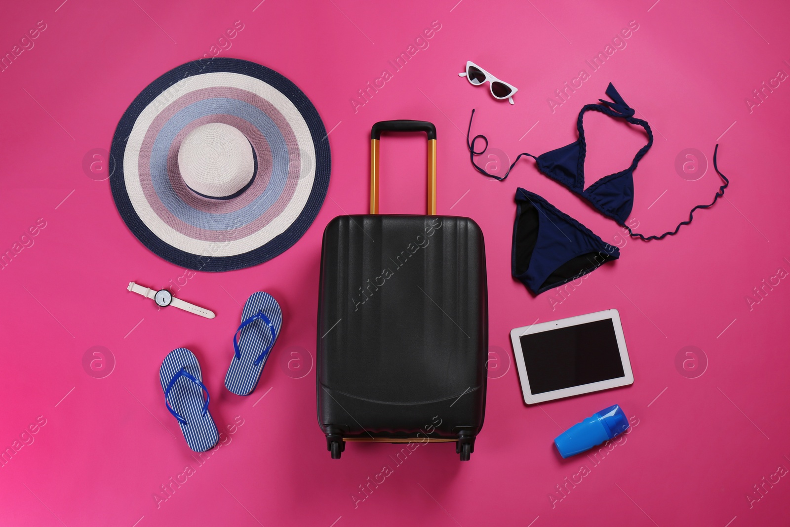 Photo of Flat lay composition with stylish suitcase and beach accessories on color background