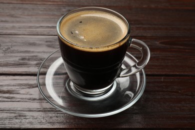 Photo of Cup of aromatic coffee on wooden table, closeup