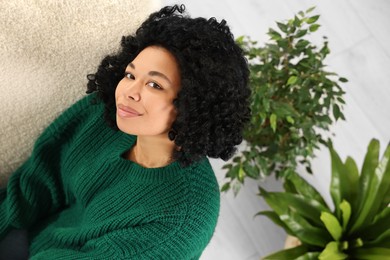 Photo of Portrait of woman relaxing near beautiful houseplants, above view