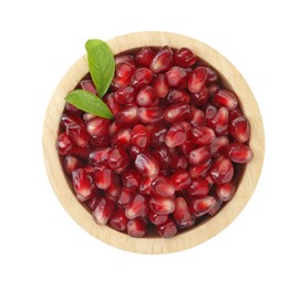 Ripe juicy pomegranate grains and leaves in wooden bowl isolated on white, top view