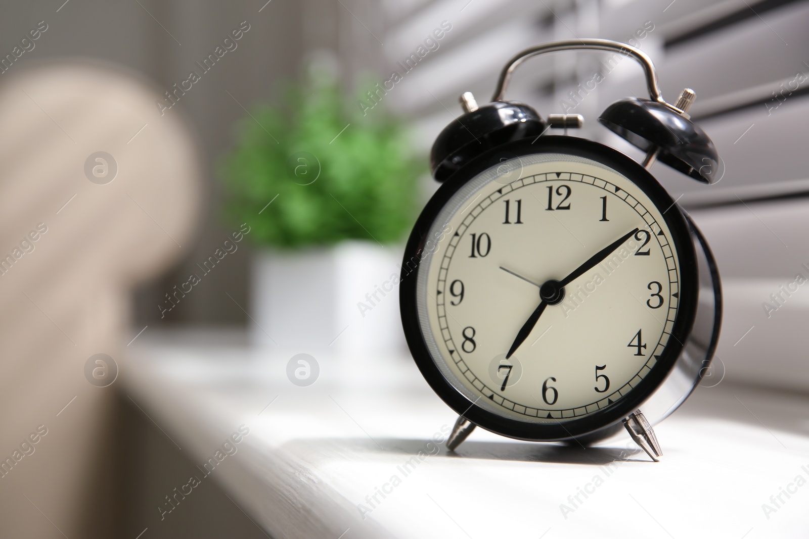 Photo of Alarm clock on windowsill, space for text. Morning time