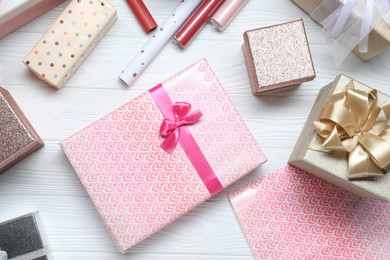 Photo of Many beautiful gift boxes on white wooden table, flat lay