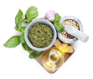 Photo of Fresh tasty pesto sauce and ingredients isolated on white, top view