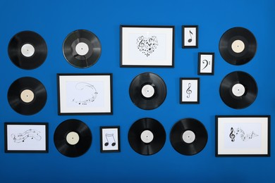 Photo of Vinyl records and different pictures on blue background