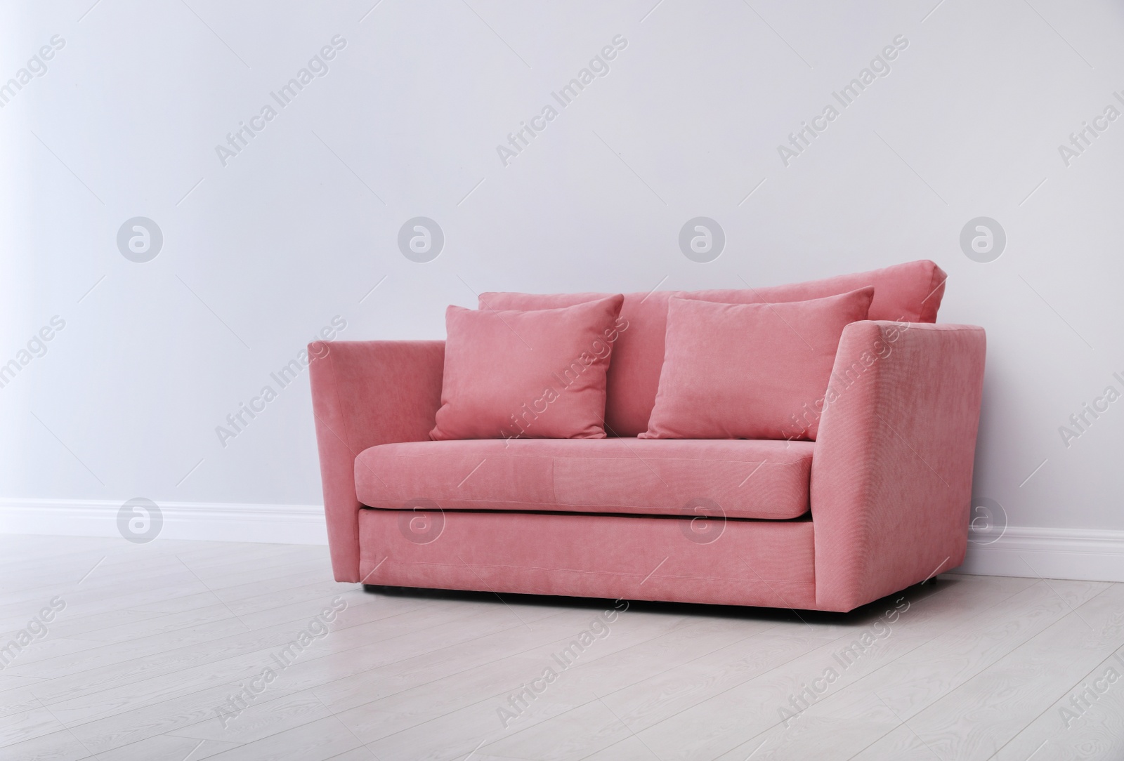 Photo of Room interior with comfortable sofa near white wall