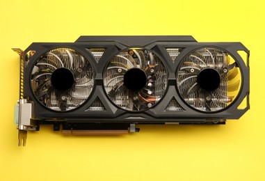 Photo of One graphics card on yellow background, top view