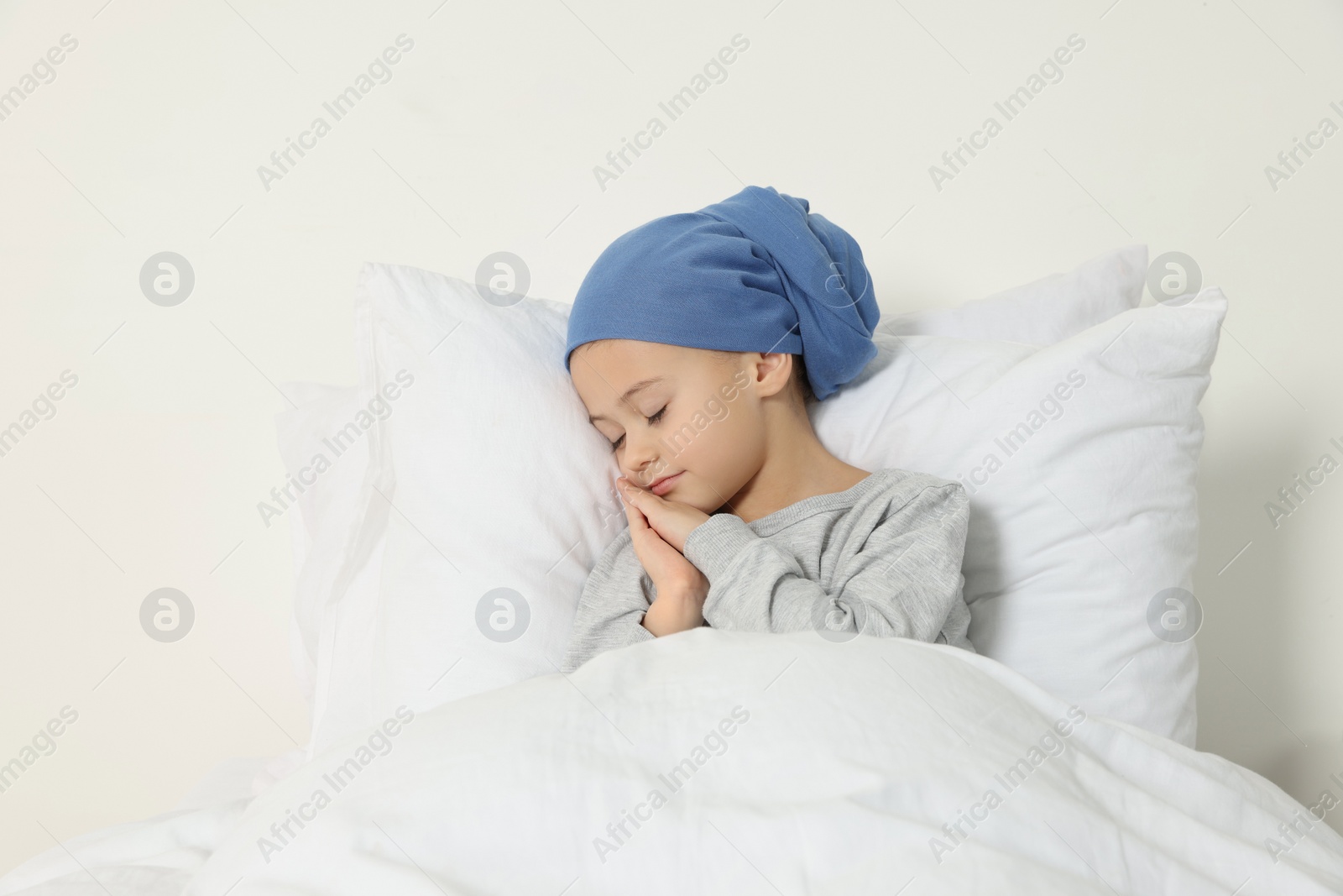 Photo of Childhood cancer. Girl sleeping in bed indoors