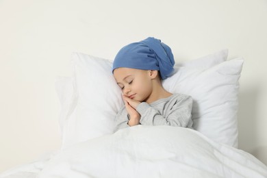 Childhood cancer. Girl sleeping in bed indoors