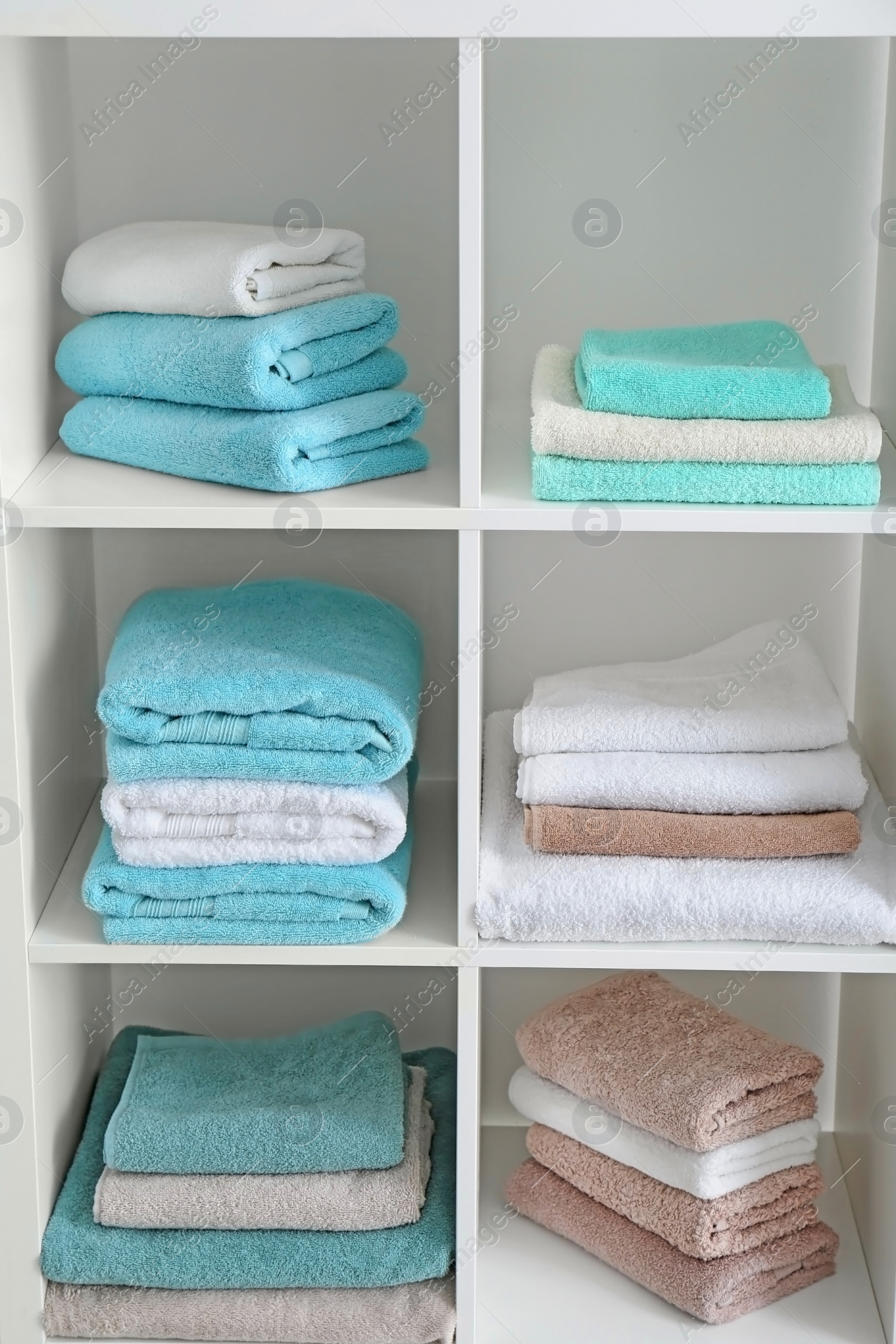 Photo of Clean towels on shelves in bathroom