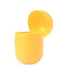 Photo of Slynchev Bryag, Bulgaria - May 23, 2023: Opened yellow plastic capsule from Kinder Surprise Egg isolated on white