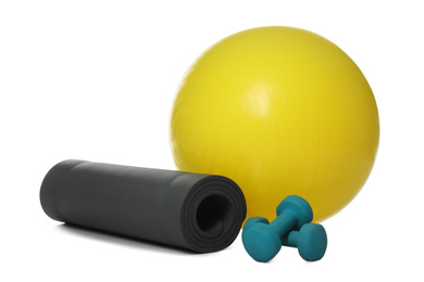 Photo of Fitness ball, yoga mat and dumbbells isolated on white
