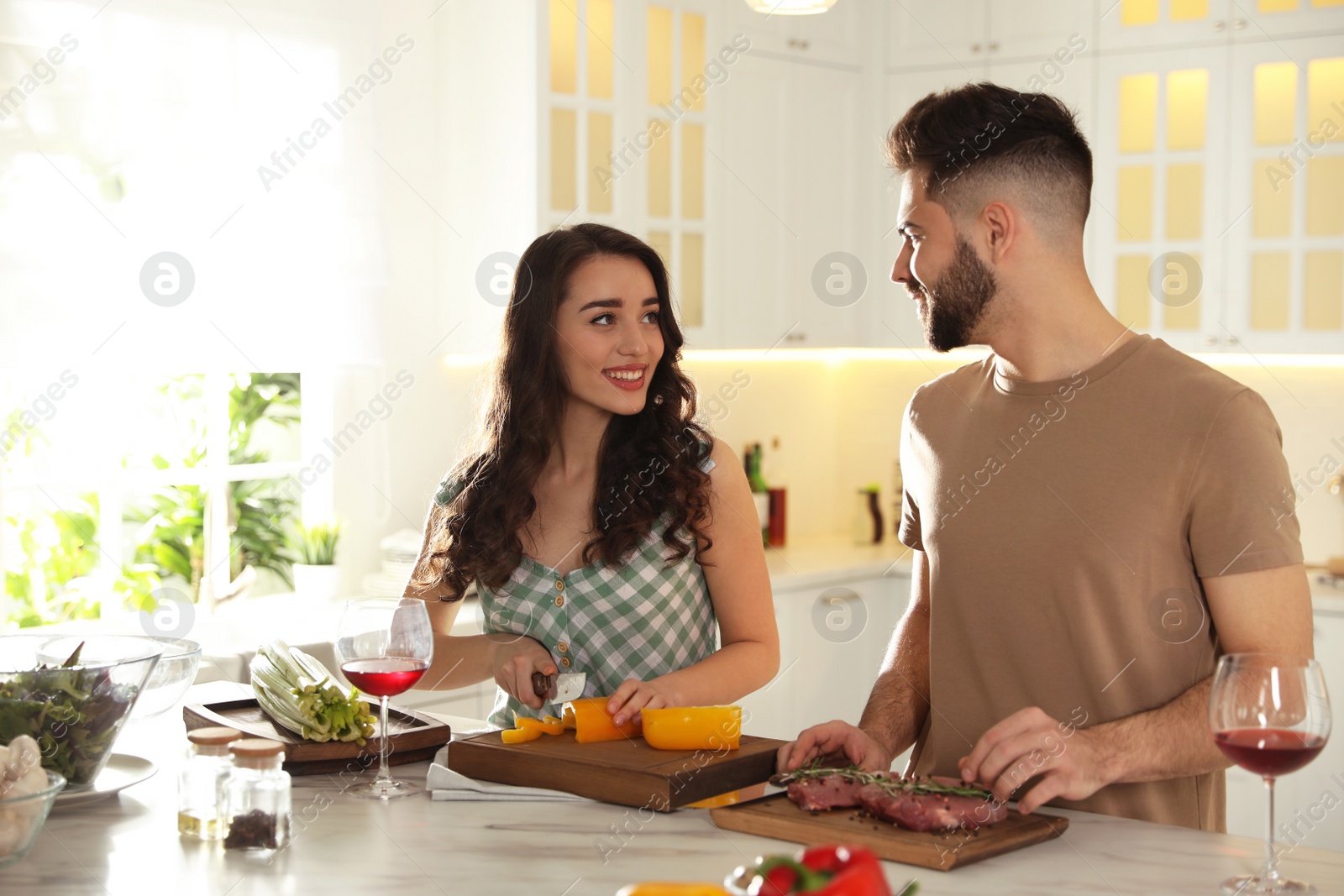 Photo of Lovely young couple cooking together in kitchen