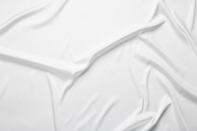 Texture of white crumpled silk fabric as background, top view