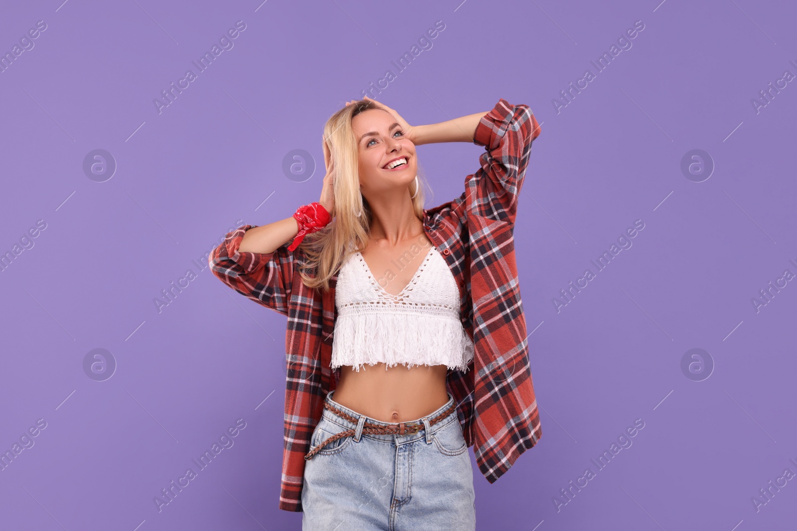 Photo of Portrait of happy hippie woman on purple background