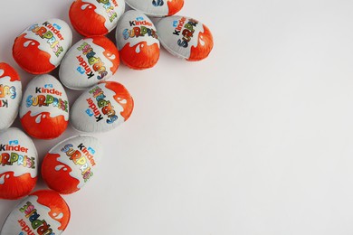 Photo of Sveti Vlas, Bulgaria - June 26, 2023: Kinder Surprise Eggs on white background, flat lay. Space for text