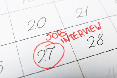 Photo of Calendar with date reminder about job interview, closeup
