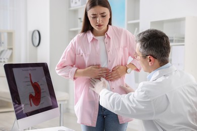 Photo of Gastroenterologist examining patient with stomach pain in clinic