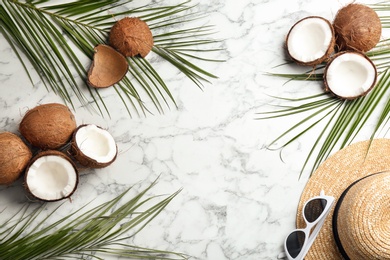 Photo of Flat lay composition with coconuts and space for text on marble background