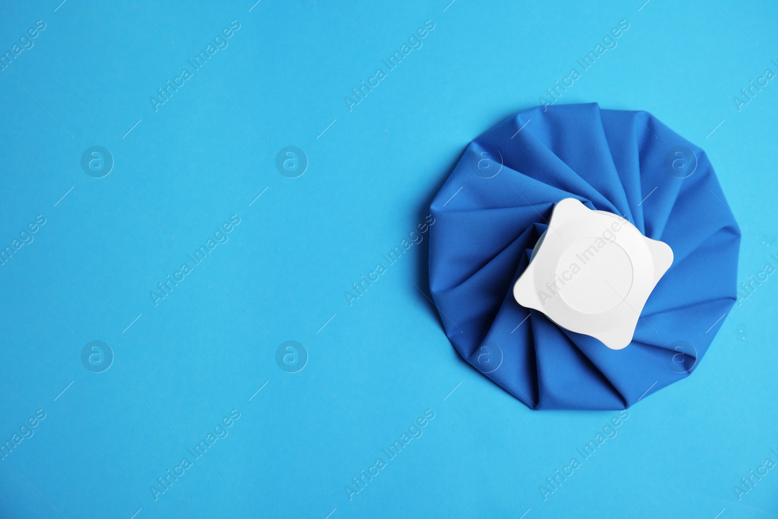 Photo of Ice pack on blue background, top view. Space for text