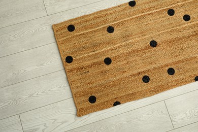 Stylish rug with dots on floor, top view