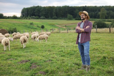 Photo of Smiling man on pasture at farm. Space for text