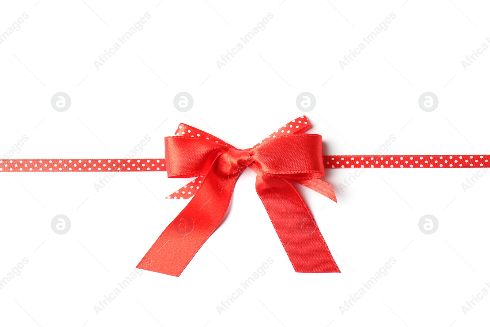 Photo of Red ribbon with bow on white background. Festive decoration