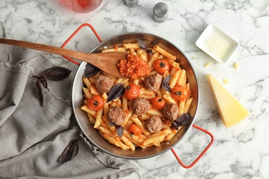 Photo of Pasta with meatballs and tomato sauce on light background