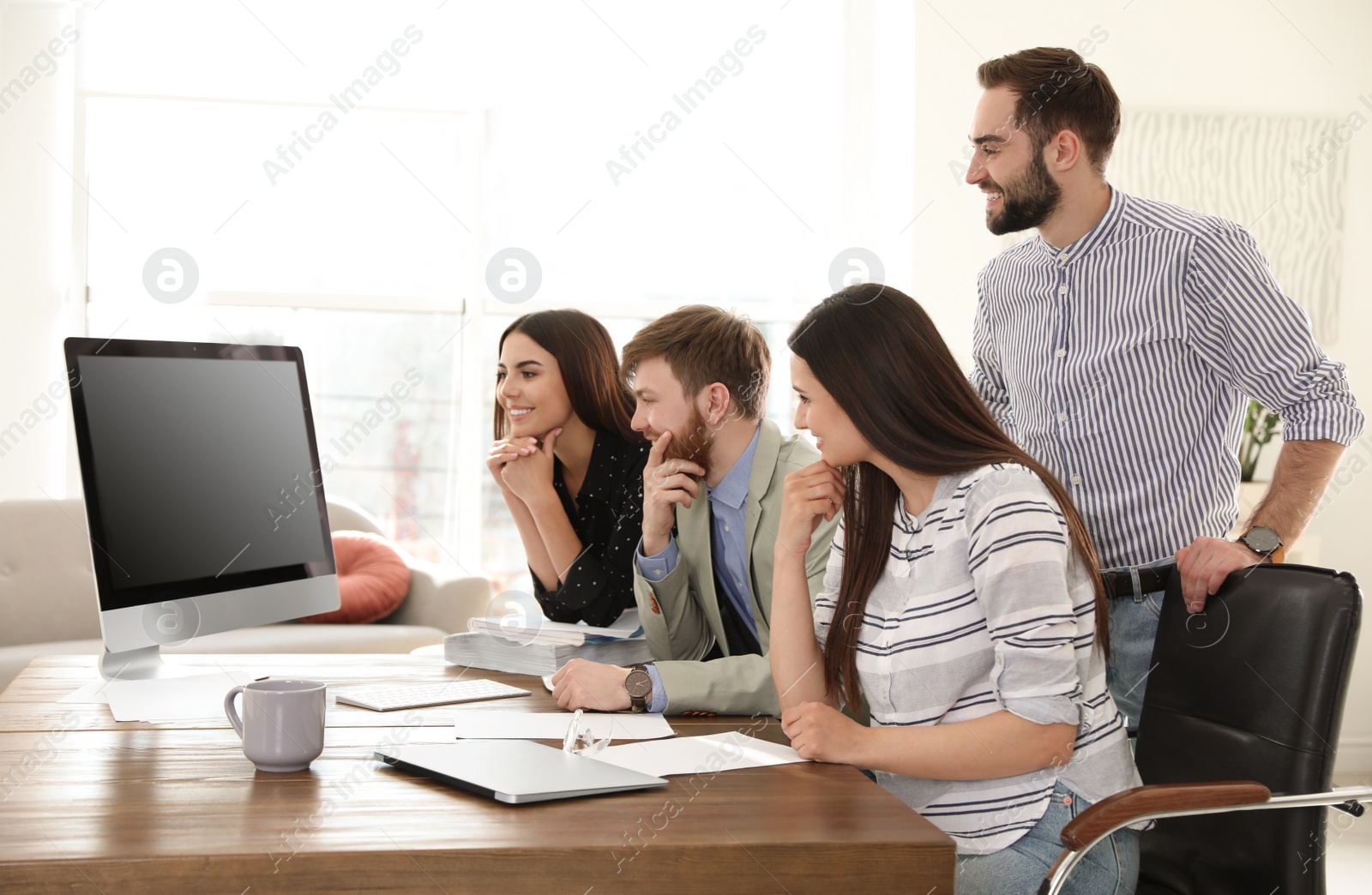 Photo of Group of colleagues using video chat on computer in office. Space for text