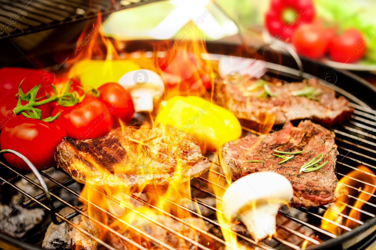 Image of Barbecue grill with food and flame, closeup