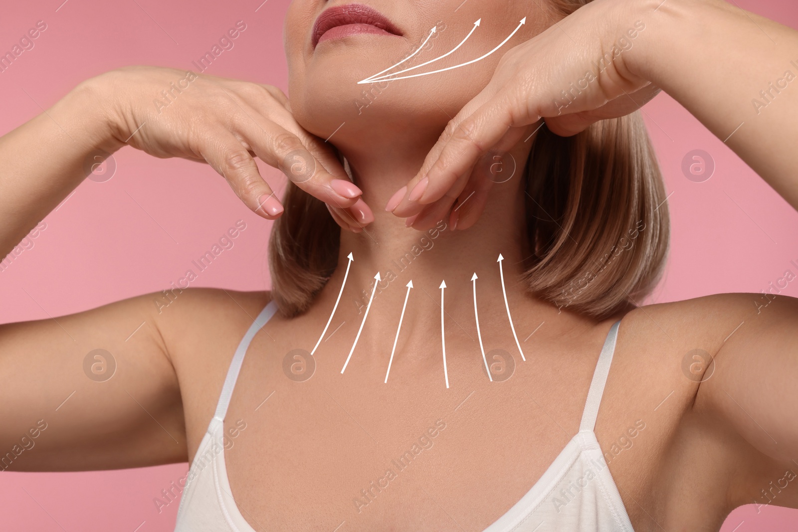 Image of Woman with perfect skin after cosmetic treatment on pink background, closeup. Lifting arrows on her neck and face
