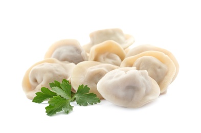 Photo of Pile of boiled dumplings with parsley leaves on white background