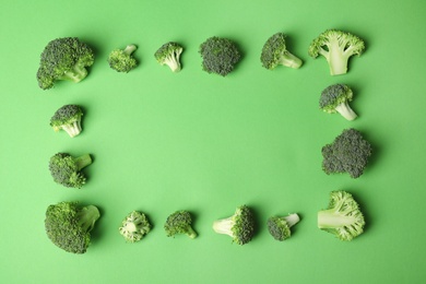 Photo of Flat lay composition with fresh green broccoli on color background. Space for text