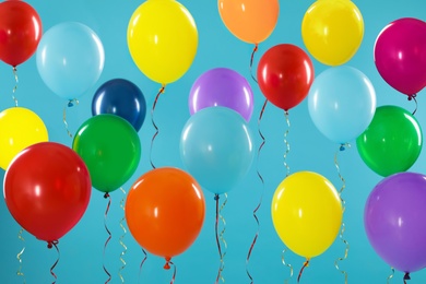 Photo of Bright balloons on color background. Celebration time