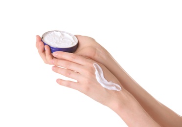 Photo of Young woman applying cream onto her hands on white background, closeup