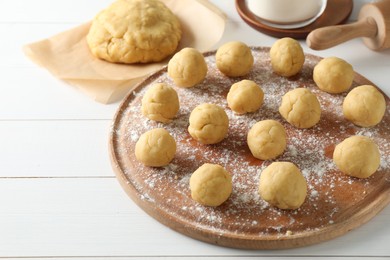Photo of Shortcrust pastry. Raw dough balls on white wooden table
