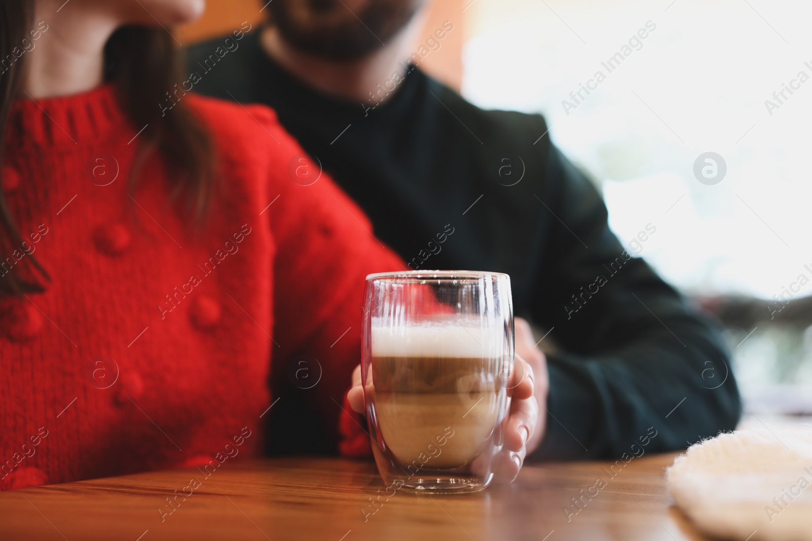 Photo of Lovely couple with fresh morning coffee at table in cafe, closeup