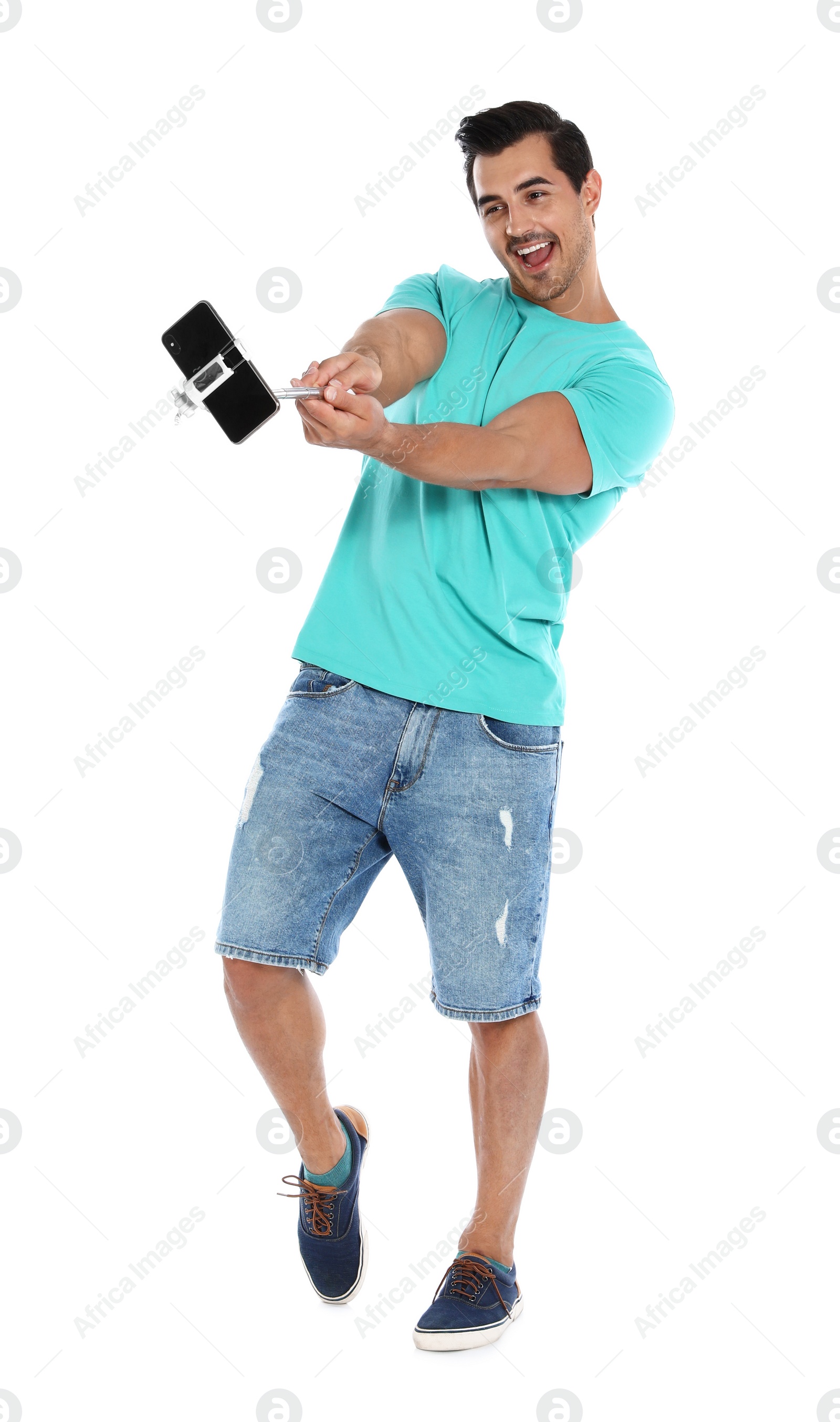 Photo of Happy young man taking selfie on white background
