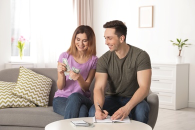 Couple managing budget to save money in living room