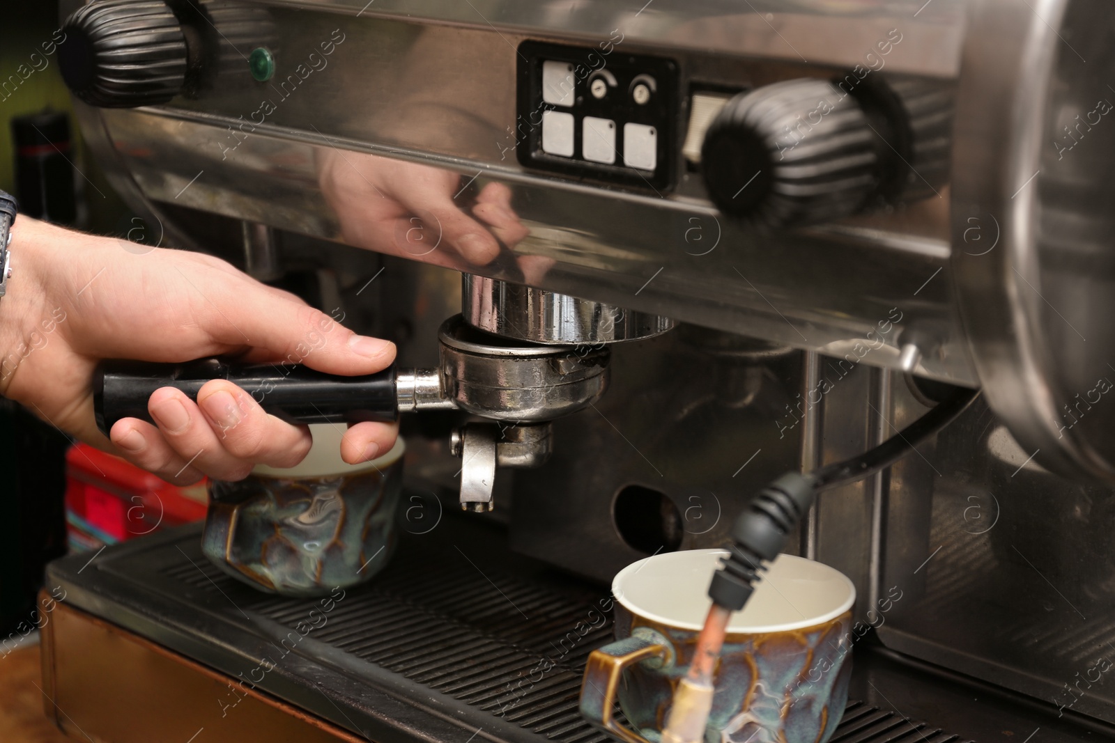 Photo of Barista preparing espresso using coffee machine, closeup