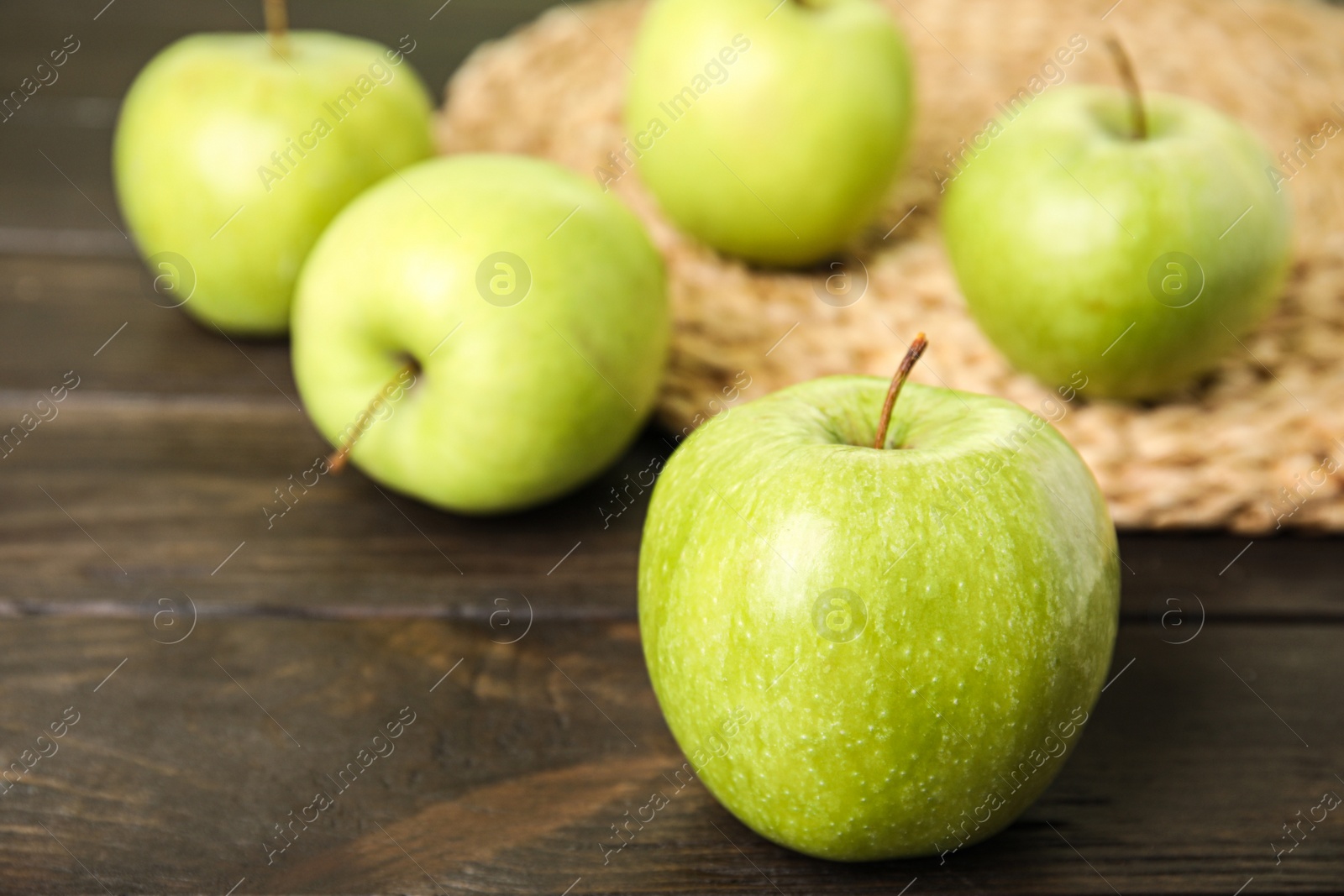 Photo of Fresh ripe green apples on wooden table, space for text