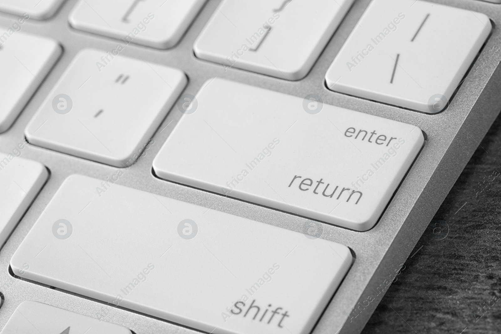 Photo of Modern computer keyboard on table, closeup view