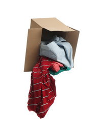 Overturned cardboard box with clothes isolated on white