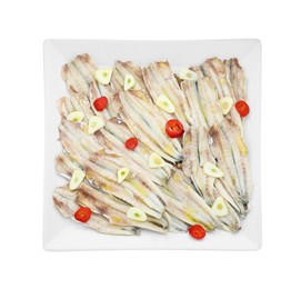 Photo of Tasty pickled anchovies with garlic and chili pepper isolated on white, top view