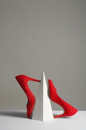 Photo of Composition with elegant female shoes on table against grey background. Space for text