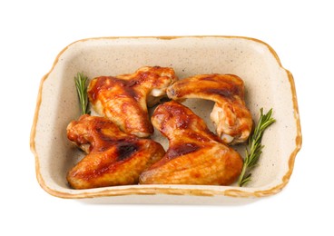 Photo of Fresh marinated chicken wings and rosemary in baking dish isolated on white