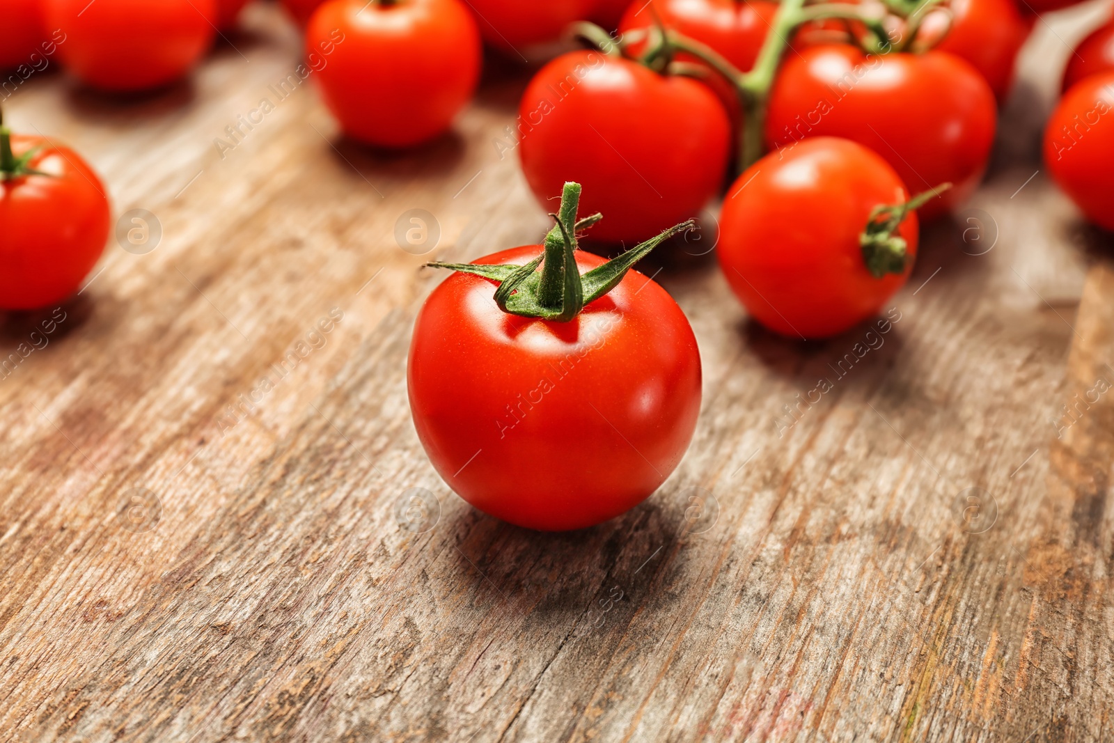 Photo of Fresh ripe red tomatoes on wooden table